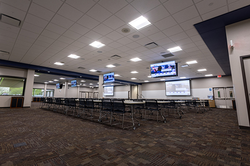 image of office area with tv's, desks, and marker boards to rent.