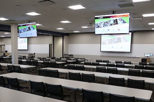 image of office area with tv's, desks, and marker boards to rent.